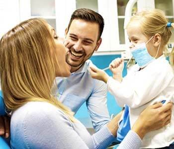 Happy family is having fun in dental office